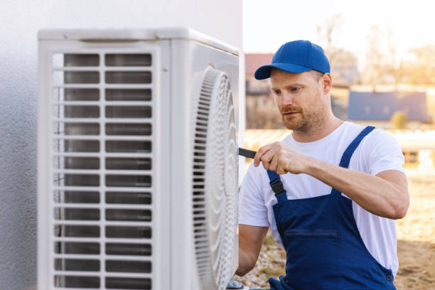 HVAC technician servicing an outdoor air conditioner in Yuba City